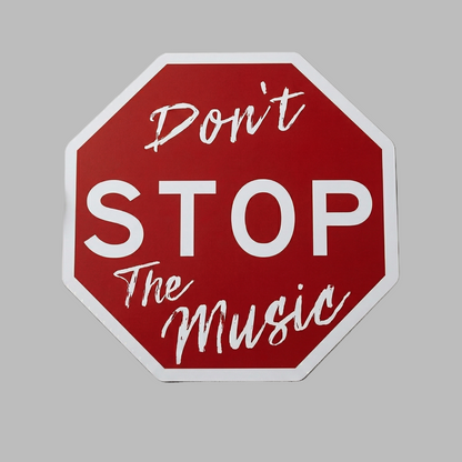 Red stop sign with 'Don't Stop The Music' text on a gray background